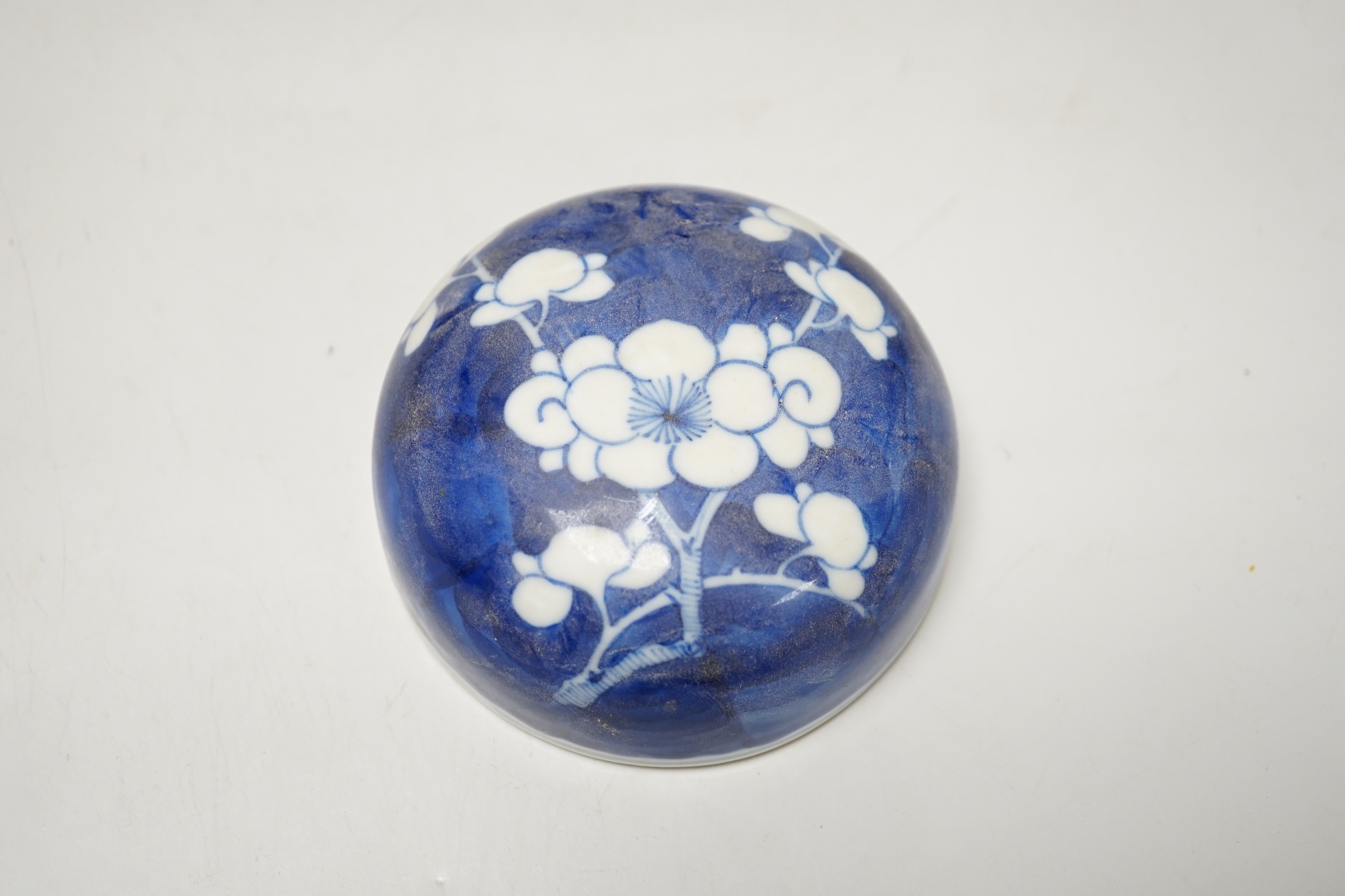 A 19th/20th century Chinese blue and white prunus jar and cover, 22cm